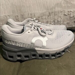 These are On Cloudmonster 2 running shoes in the Frost Rock colorway
